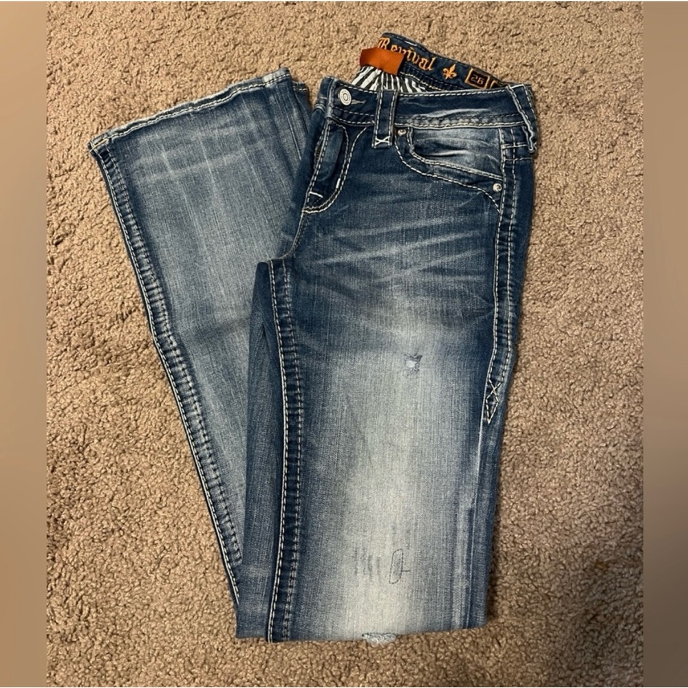 Rock Revival bootcut mid rise distressed jeans.